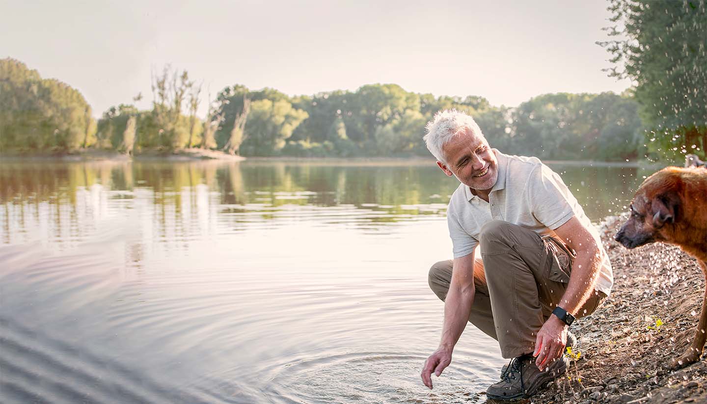 Man with dog at lake